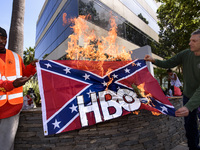 Activists burn a Confederate flag with the HBO logo in protest of HBO’s new series in development, Confederate. Santa Monica, California on...