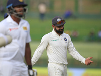 Indian cricket captain Virat Kohli reacts after Sri Lanka's 1st innings finished during the 2nd Day's play in the 3rd Test match between Sri...