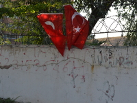 Two Turkish flags can be seen hanging on a fence in Ankara, Turkey on August 13, 2017. (