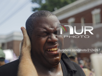 A Counter protester suffers the affects of a pepper spray attack by White Supremacists on 12 August 2017 in Charlottesville, Virginia, USA....