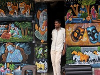 Ahead of the Independence Day, paintings were displayed in Delhi's busiest market, as one of the sellers awaits customers on the hot and hum...