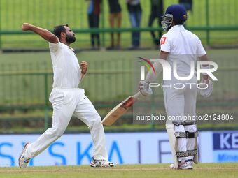 Indian cricketer Mohammed Shami(L) celebrates after taking the wicket of Sri Lanka's Kusal Mendis during the 3rd Day's play in the 3rd and f...
