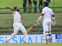 Indian cricketer Mohammed Shami(L) celebrates after taking the wicket of Sri Lanka's Kusal Mendis during the 3rd Day's play in the 3rd and f...