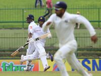 Sri Lankan cricket captain Dinesh Chandimal and Angelo Mathews run between the wickets during the 3rd Day's play in the 3rd and final Test m...