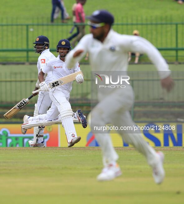 Sri Lankan cricket captain Dinesh Chandimal and Angelo Mathews run between the wickets during the 3rd Day's play in the 3rd and final Test m...