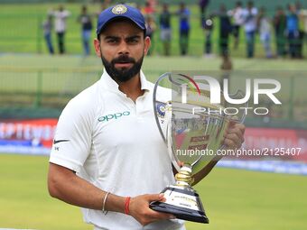 Indian cricket captain Virat Kohli poses with the winners trophy after the 3rd Day's play in the 3rd and final Test match between Sri Lanka...