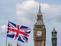 An Union Flag is seen waving on the top of a souvenir shop, against the backdrop of the Elizabeth Tower, commonly known as Big Ben, in Londo...