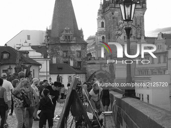 Tourists on the Charles Bridge is the oldest bridge in Prague, and crosses the Vltava River from the Old Town to the Small Town was built in...