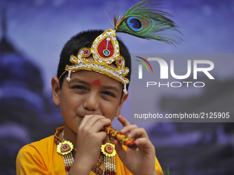 A Kid impersonate as Lord Krishna during Krishna Janmashtami Festival celebrated at ISKON Nepal, Budhanilkantha, Kathmandu, Nepal on Monday,...