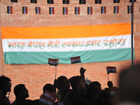 A Nepalese volunteer distributing miniature tricolor India Flag to the people during celebration of India's 71st Independence Day at Kathman...