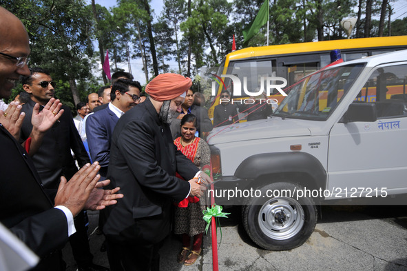 Indian Ambassador to Nepal Manjeev Singh Puri cuts the ribbon to give 30 Ambulances & 6 buses to hospitals at the Embassy premises to during...