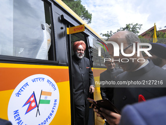 Indian Ambassador to Nepal Manjeev Singh Puri observes bus after cuts the ribbon to give 30 Ambulances & 6 buses to hospitals at the Embassy...