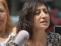 A woman reads a press statement as anti-government demonstrators gathered in front of the Supreme Election Council (YSK) to protest against...