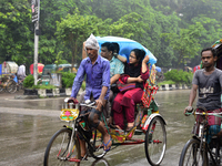 Bangladesh rickshaw drives with passenger on the street during rainy day in Dhaka, Bangladesh. On August 16, 2017

 (