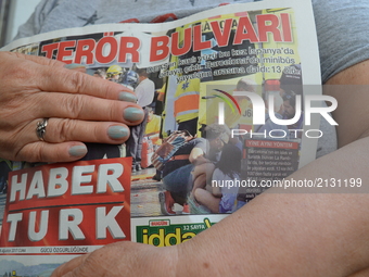 A woman holds a copy of Turkey's one of mayor daily newspapers Haberturk in Ankara, Turkey on August 18, 2017 as the daily depicts the terro...