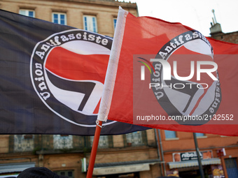 Two antifascism flags during a gathering in Toulouse in solidarity with anti-fascists in Charlottesville after the killing of Heather Heyer...