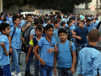 Palestinian schoolboys chat as they head to school on the first day of a new academic year,  in Gaza City on August 23, 2017
 (