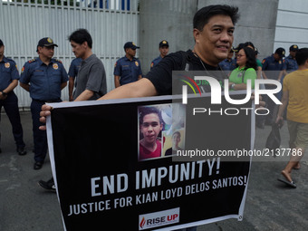 A protester holds a placard during a rally against the recent killing of 17 year old Grade 11 student Kian Lloyd Delos Santos on Wednesday,...