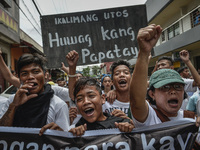 Residents and activists chant slogans during the funeral procession of Kian Loyd Delos Santos in Caloocan, Metro Manila, Philippines, August...