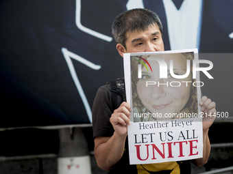 A participant holds a photo of Heather Heyer during the standing silent appeal, a hundred people gathered in shibuya against racism and viol...