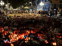 People display flowers, messages and candles to pay tribute to the victims of the Barcelona and Cambrils attacks in Cambrils on August 26, 2...