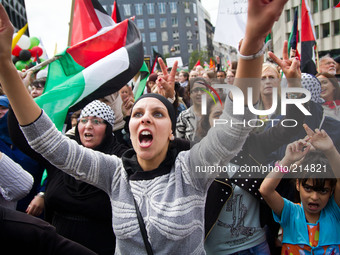 About 4000 people marched today in the streets of Brussels to ask the end of the blockade in Gaza, on August 17, 2014. People waving Palesti...