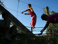 Rohingya children cross the Bangladesh-Myanmar border fence as they try to enter Bangladesh in Bangladesh-Myanmar border.  on 30 August 2017...