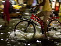 A cycle rider crossing a flooded street of Calcutta after a heavy rain.
1st September 2017. Calcutta. India. (