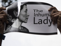 An Indonesian protester tears a picture of Myanmar's Aung San Suu Kyi during a rally in front of Myanmar embassy in Jakarta on September 2,...