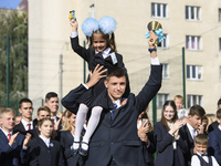 Schoolchildren attend a ceremony to mark the start of the school year in Kyiv, Ukraine September 1, 2017. (