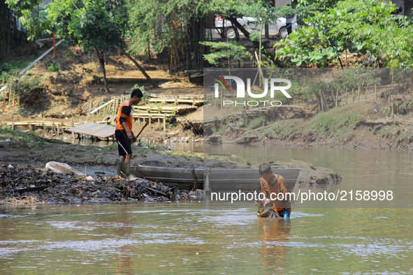 Officers cleared trash on the banks of the Ciliwung river, Jakarta, Indonesia, Sunday, September 3, 2017. Based on Jambeck data in 2015, Ind...