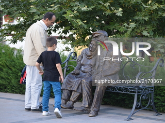 A man and a boy look at a statue in the historic Hamamonu district of Ankara, Turkey on September 07, 2017. Hamamonu is a historic district...
