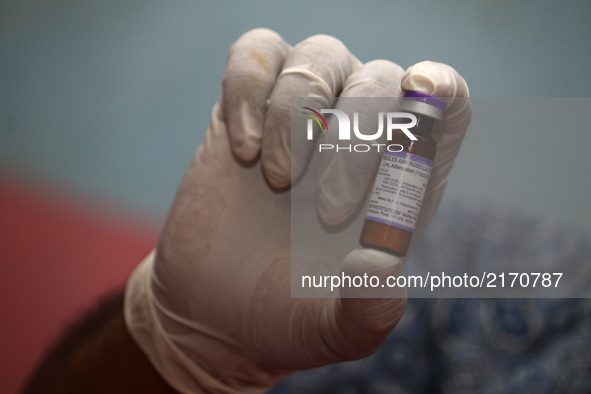 Health officers preparing the Measles Rubella vaccine before immunization at an integrated health service post in Wanasari Village, West Jav...