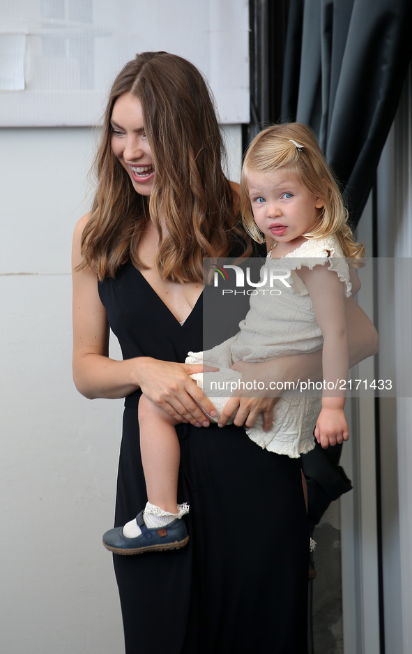 Venice, Italy. 08 September, 2017.  Christina Ferrara, wife of director Abel Ferrara poses with her daughter during the 'Piazza Vittorio' ph...