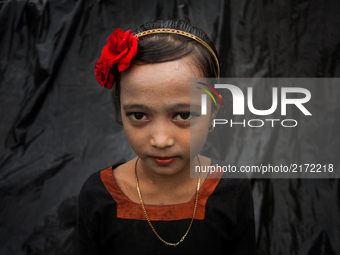 Rohingya ethnic minority girl pose at a temporary makeshift camp after crossing over from Myanmar into the Bangladesh side of the border, ne...