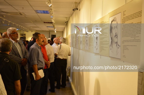 People look at portraits of the victims on the opening day of the September 12 Shame Museum, which is held with the help of the main opposit...