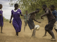 Children in Malawi play a game of football after having a bible study together. (