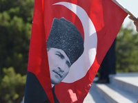 A man holds a Turkish flag during a march marking the 94th anniversary of the main opposition Republican People's Party (CHP) at Anitkabir,...