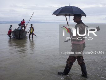 Rohingya ethnic minority people fleeing to a temporary makeshift camp, crossing Naf river, after crossing over from Myanmar into the Banglad...