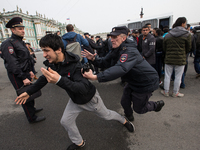 Police officers detain a demonstrators during a protest in Palace Square in St. Petersburg, against persecution of Rohingya Muslims in Myanm...