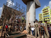 ODRF (Odisha Disaster Response Force) and fire fighters look near the under construction bridge collapse area as they are busy in the rescue...