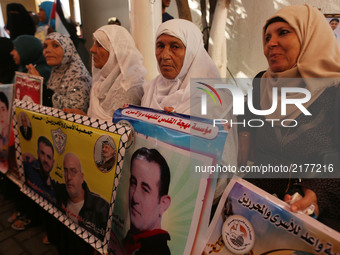 Palestinians take part in a protest to show solidarity with Palestinian prisoners held in Israeli jails, in front of Red cross office in Gaz...