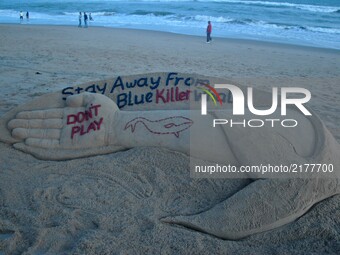 Indian sand artist Sudarshan Patnaik is creating a sand sculpture about the Blue Whale game for public awareness at the Bay of Bengal Sea’s...