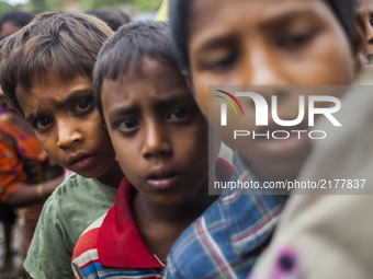 Rohingya Muslim refugees wait for relief near a camp at a temporary makeshift shelters after crossing over from Myanmar into the Bangladesh...
