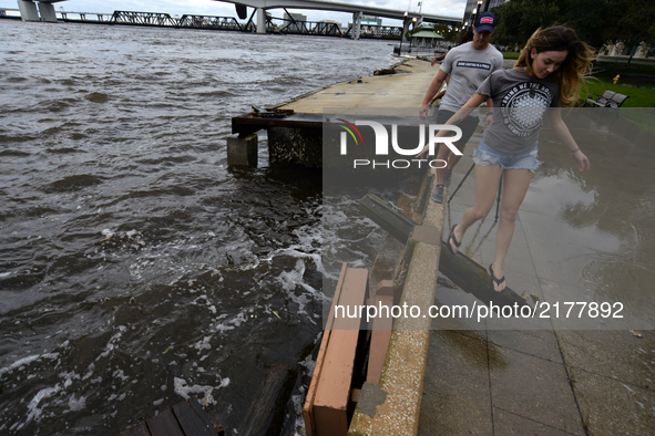 People walk around Riverwalk Brooklyn, Jacksonville after flood water resides from parts of Jacksonville, FL after Hurricane Irma took an un...