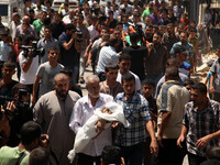 Palestinian mourners carry The body  child Ali Mohammed Deif ,. Hamas's top military commander Mohammed Deif, whose wife and child were kill...