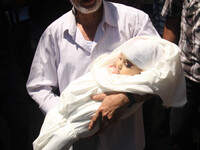 A relative of the wife of Hamas's military leader, Mohammed Deif, and his infant son Ali, whom medics said were killed in Israeli air strike...