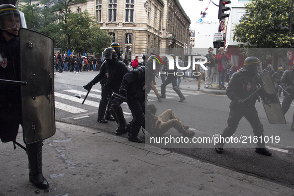 Police riot is taken a demonstrator down during protests against labor law in Paris, France on September 12th, 2017. French unions launched...