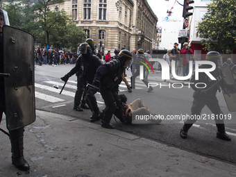 Police riot is taken a demonstrator down during protests against labor law in Paris, France on September 12th, 2017. French unions launched...