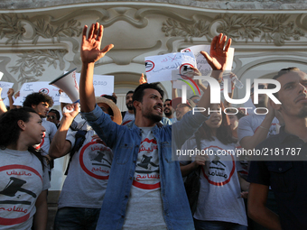 Protesters raise their arms during a rally held by the movement 